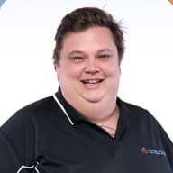 Ji's headshot, smiling with black tee