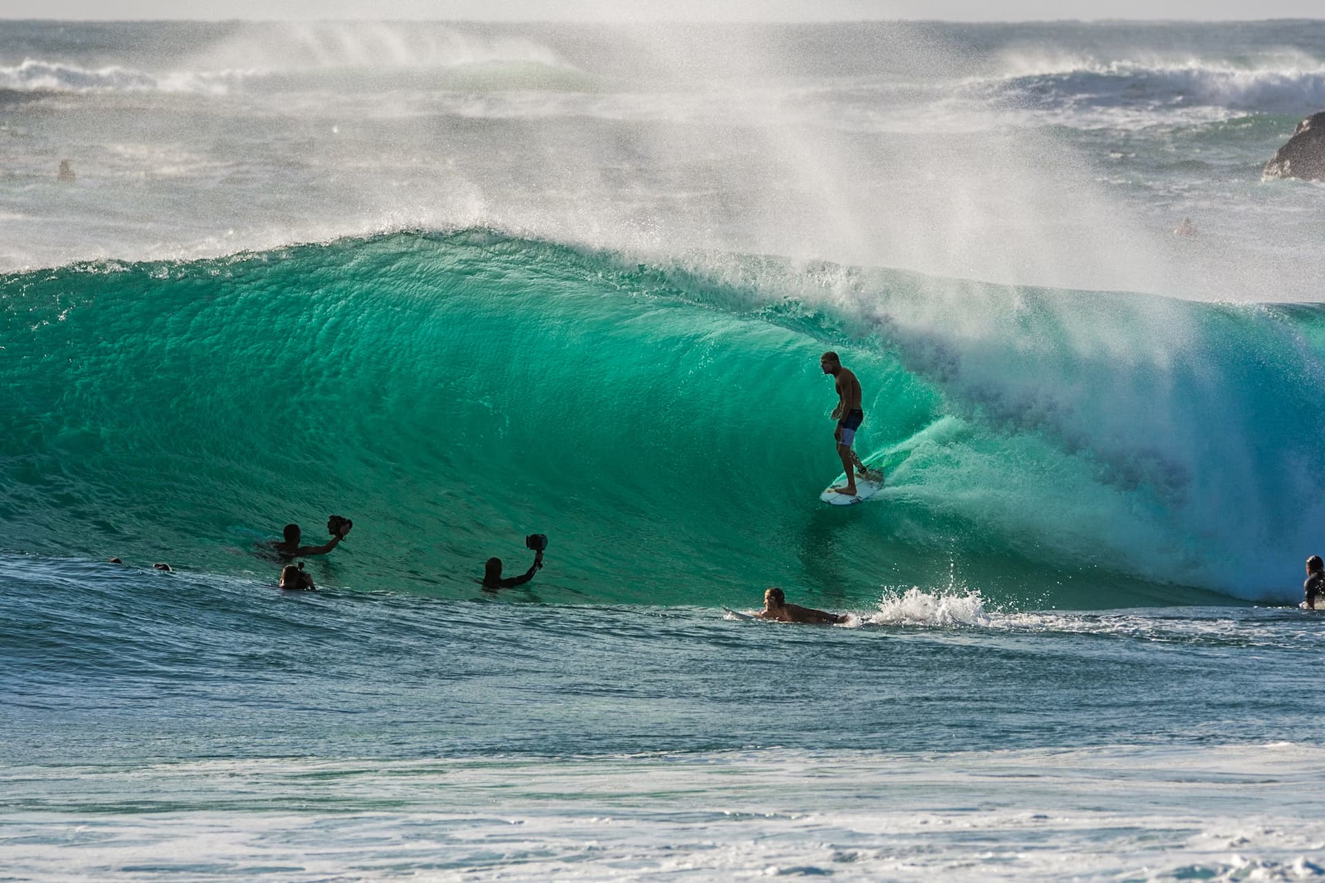 A man surfing on a ocean wave